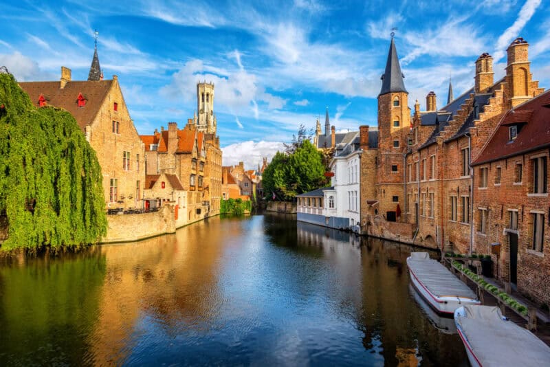 A scenic view of a city canal with historic buildings and boats in a European city.