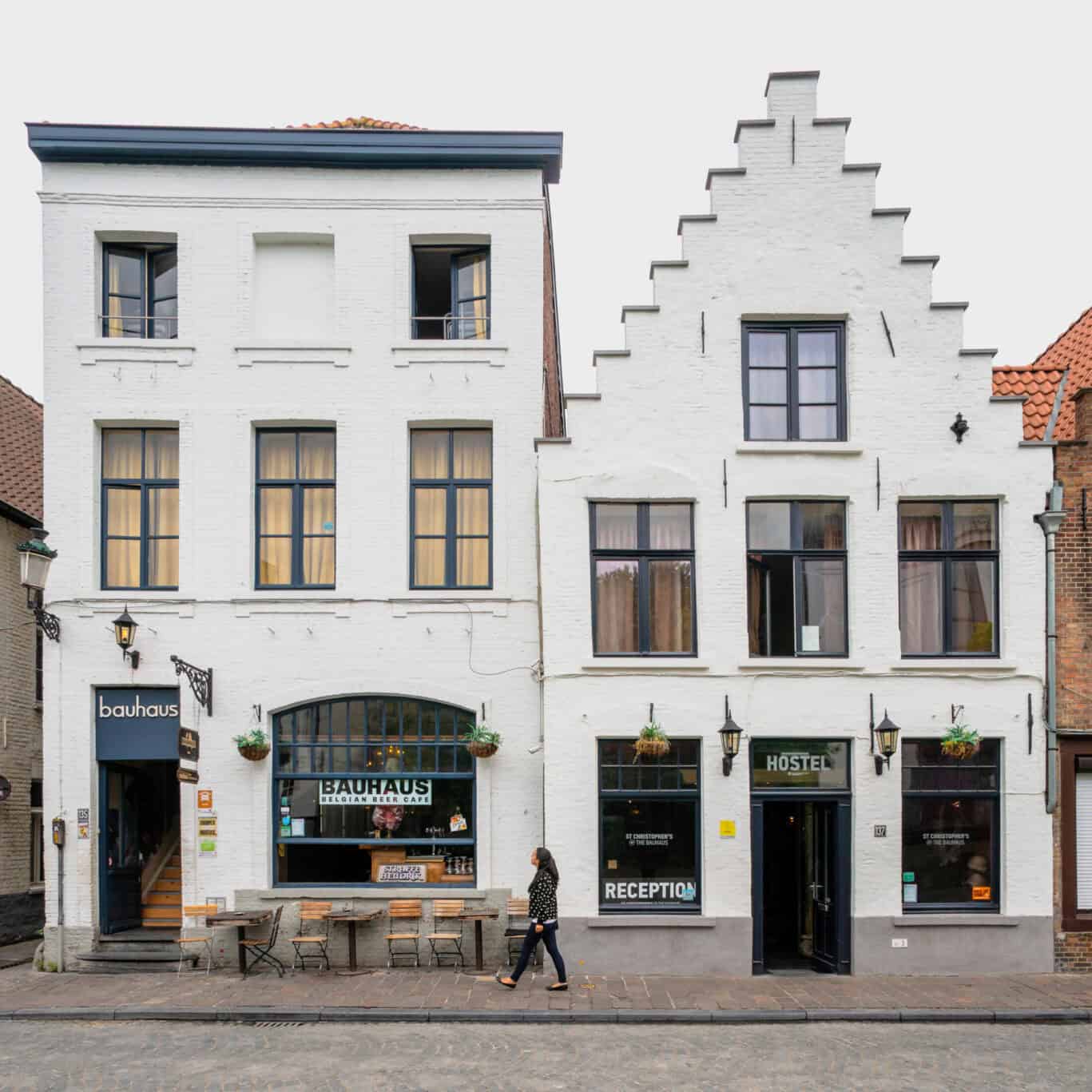 A street view of a hostel building with a bar and reception area.
