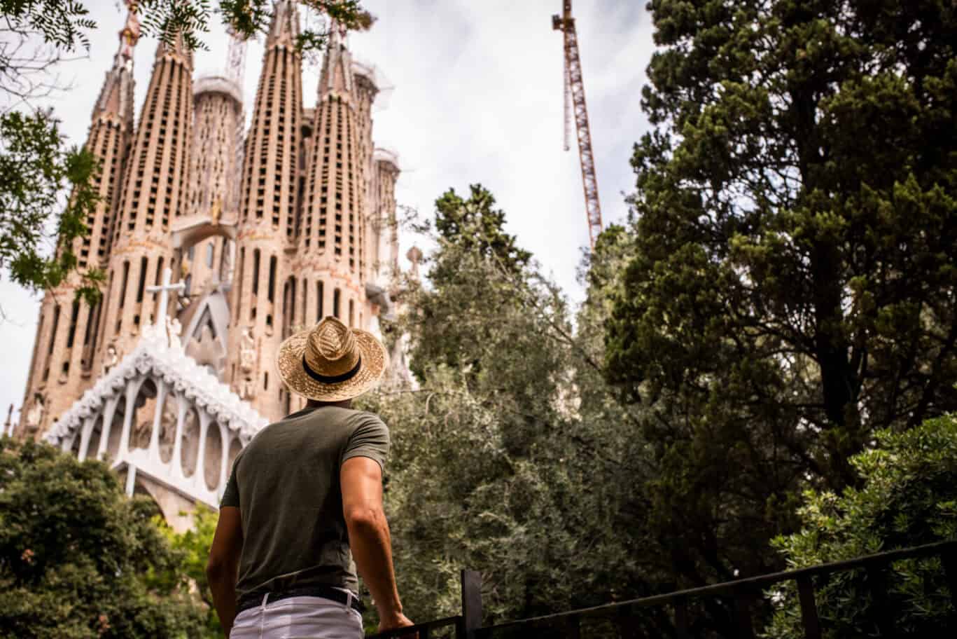 A traveller looking at the Sagrada Familia in Barcelona, Spain.