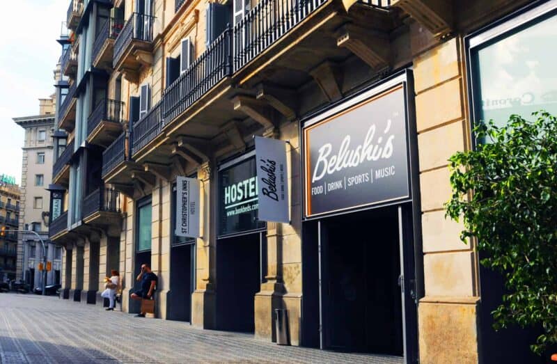 Exterior view of a Belushi's bar with signage and outdoor seating.