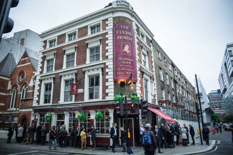The Flying Horse pub at Liverpool Street, near St Christopher's Inns in London, with people outside.