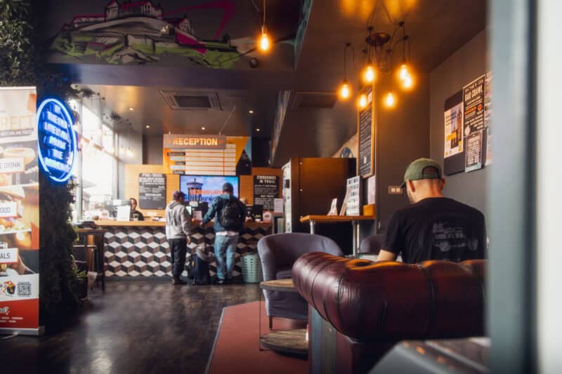 Historic Edinburgh hostel reception area with modern decor and friendly staff.