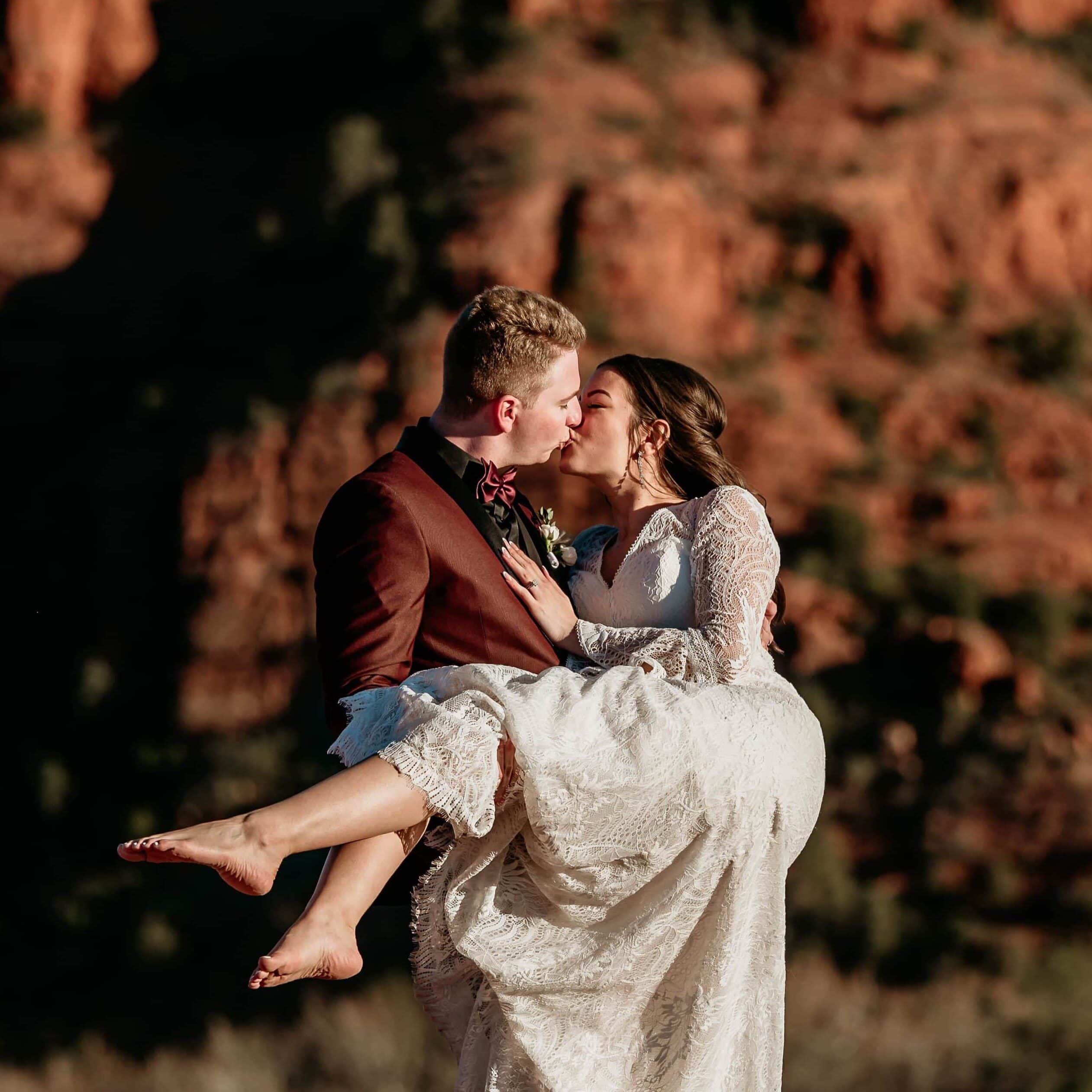 Groom carrying bride in a kiss during their Arizona elopement