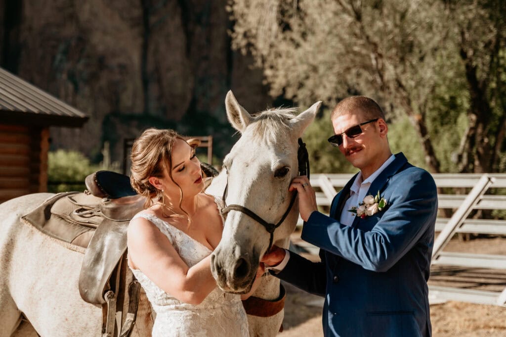 Couple petting horse during their Arizona elopement by Stratus Photography