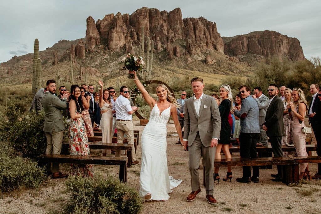 Couple celebrating with their family and friends behind them for their Arizona elopement by Stratus Photography