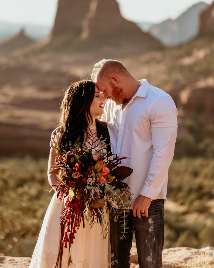 Elopement couple with giant wildflower bouquet in Sedona, Arizona