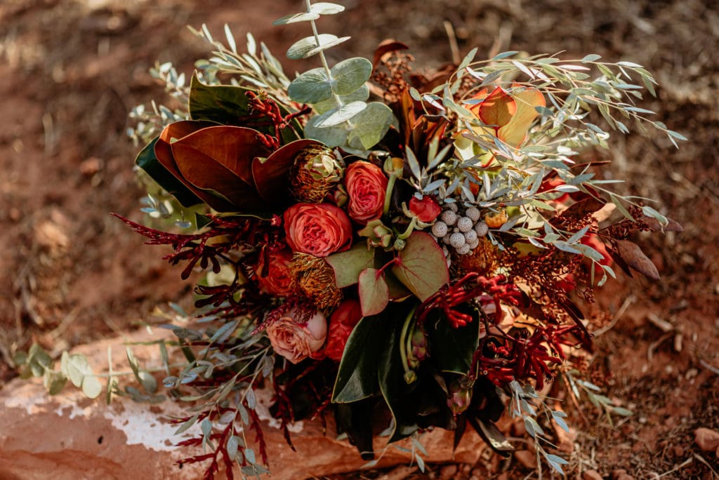 Gorgeous Red, Orange, and vibrant earth toned bouquet by Wildflower Design Co