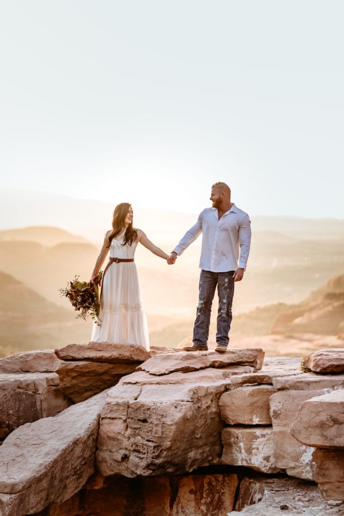Bride and groom look at each other while holding hands during their Sedona elopement
