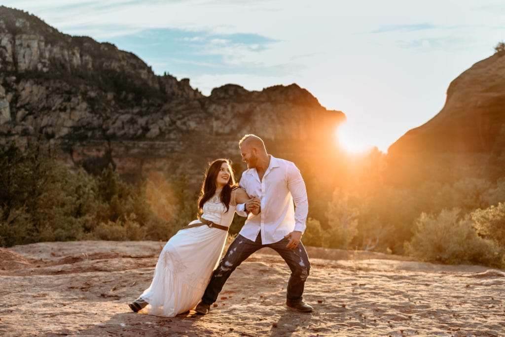 Gorgeous Sedona sunset behind dancing wedding couple