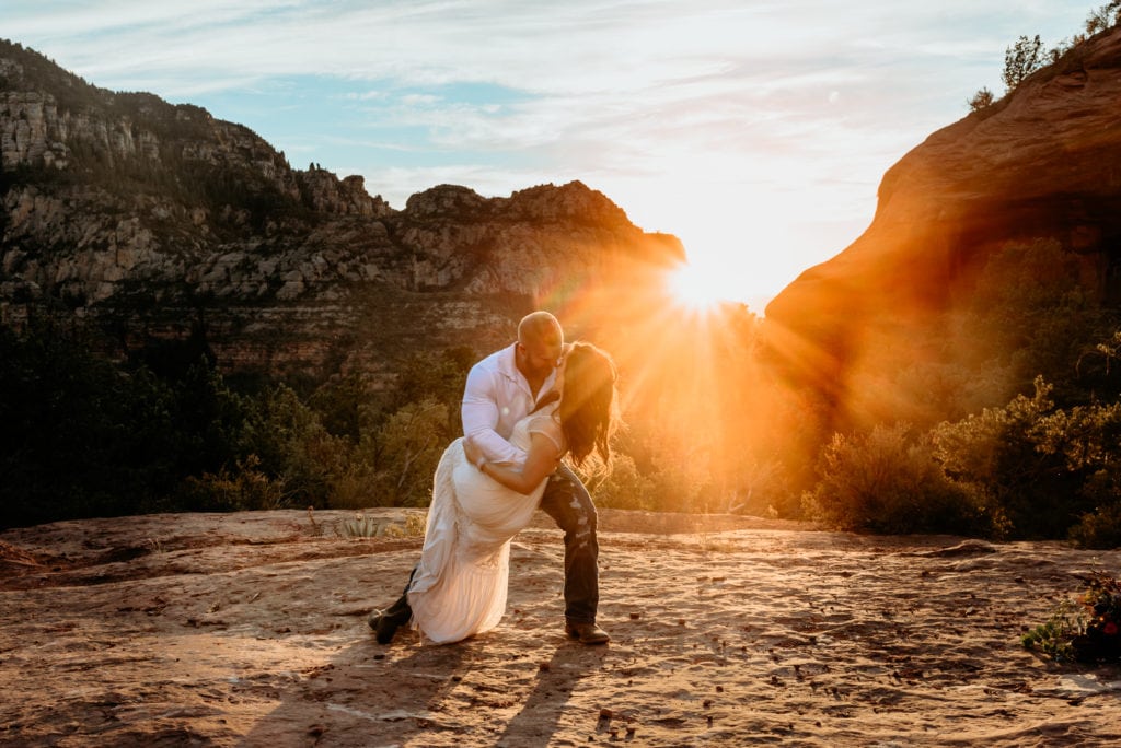 Kiss during bride and grooms first dance at Merry Go Round Rock in Sedona, Arizona