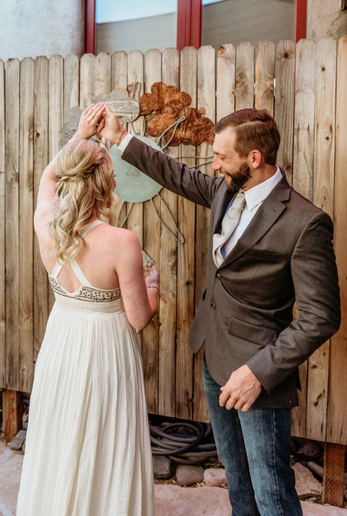 Tyler spinning Brie to look at her whole dress and hair style for their wedding day