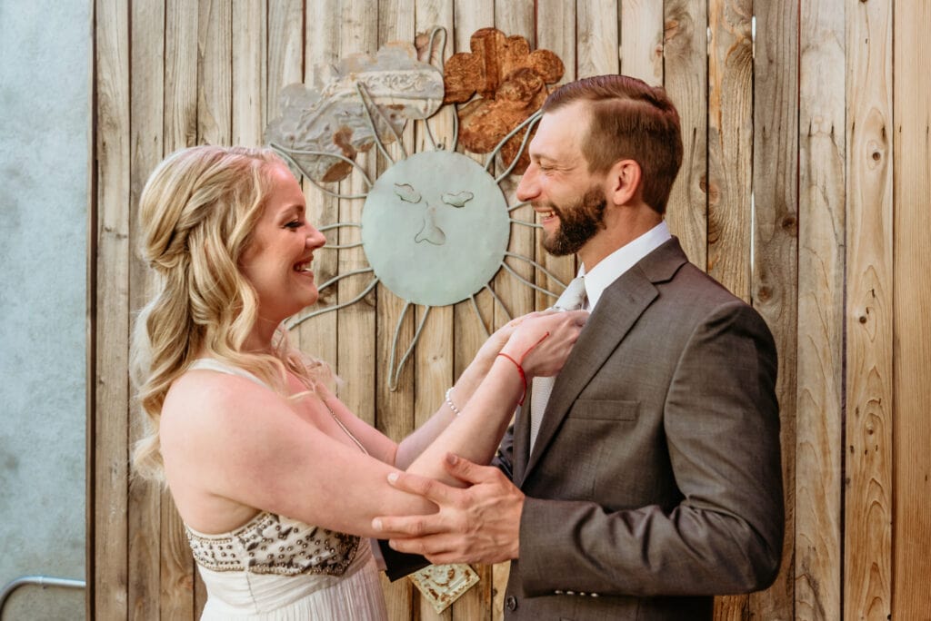 Brie fixing Tyler's tie before leaving for their elopement