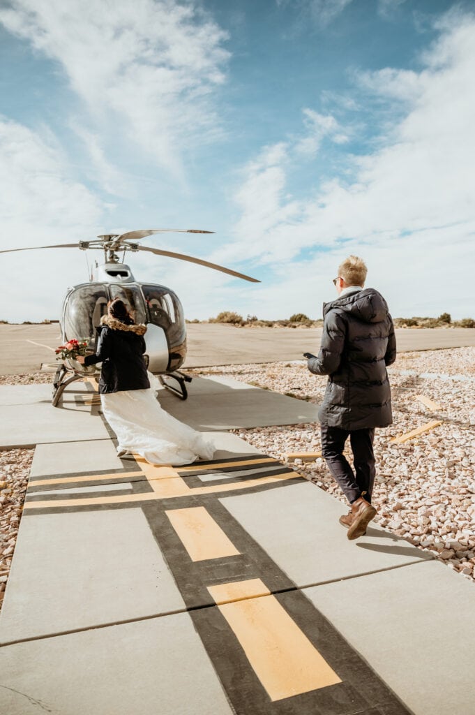 Couple walking out to Maverick Helicopter to fly down into the Grand Canyon