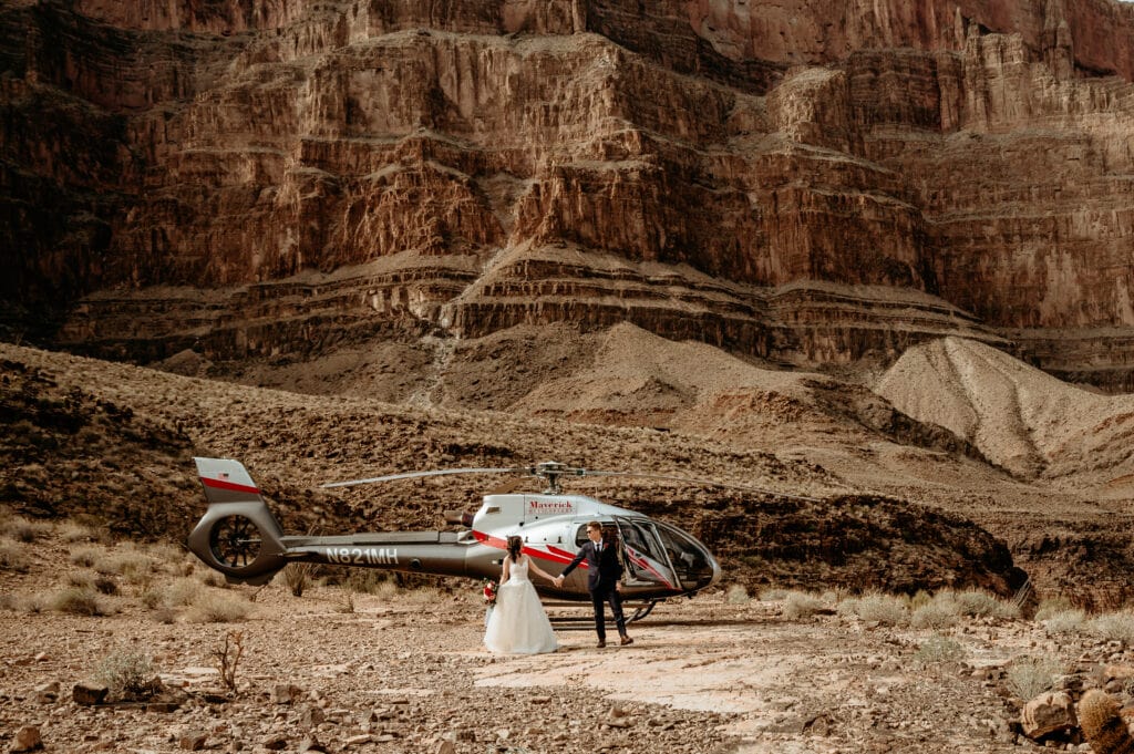Couple walking hand in hand during their Grand Canyon helicopter elopement