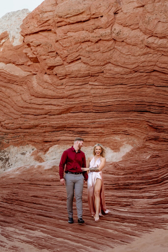 Cassie and Nick walk hand in hand at the Vermillion Cliffs