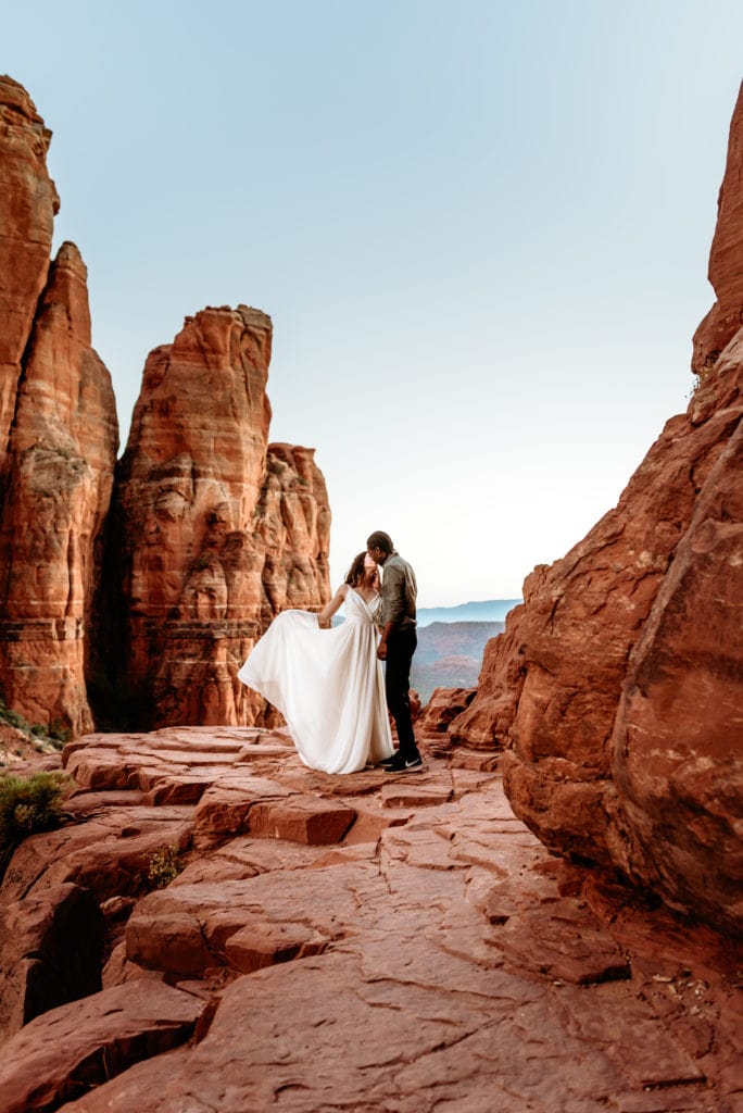 A dramatic kiss at the peak of Cathedral Rock by sweet elopement couple