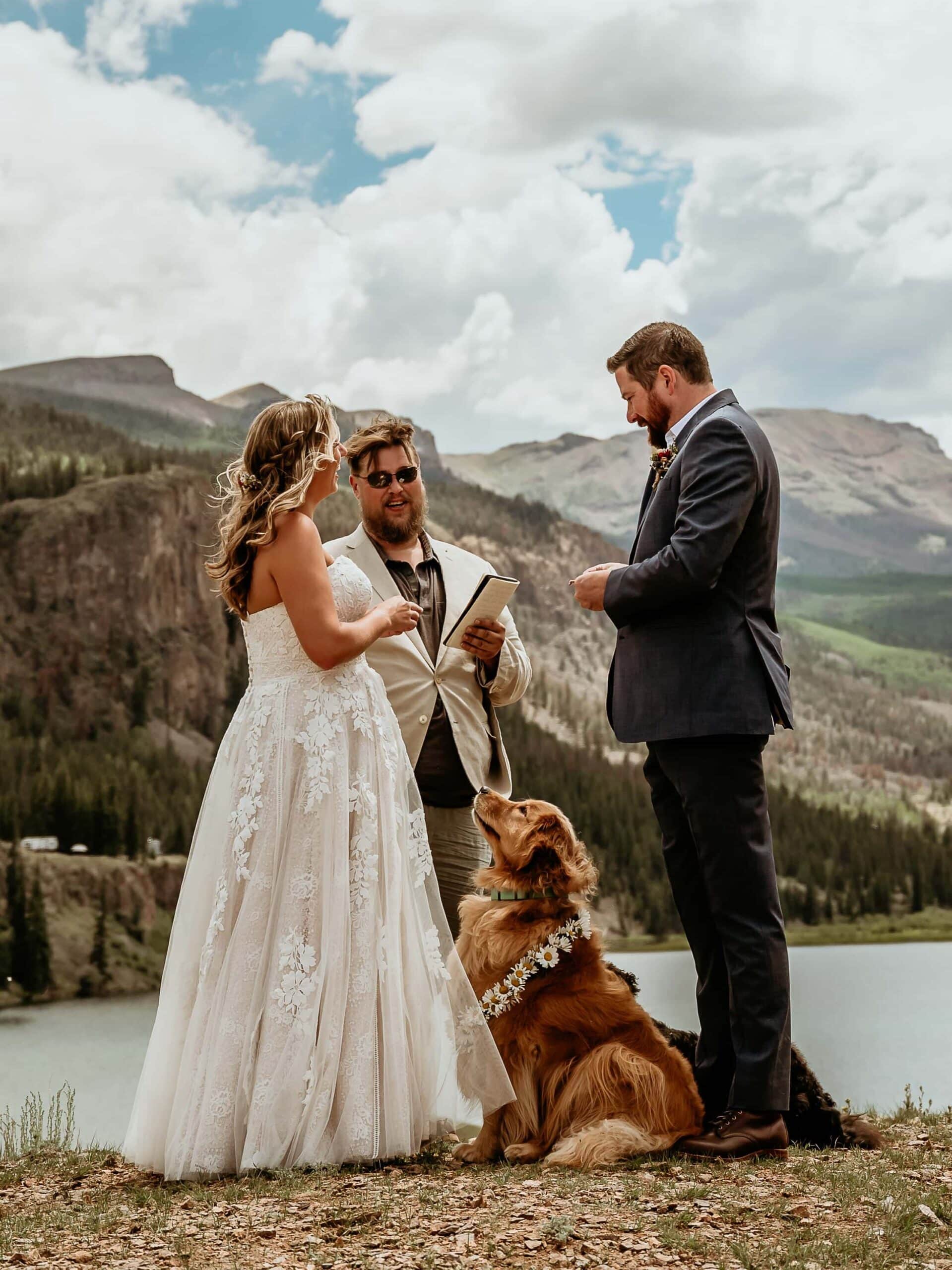 San Juan Mountains elopement with flower pup looking up at the bride during their ceremony