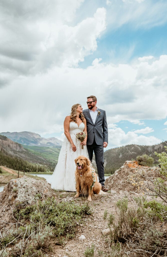 Couple and their pup in the San Juan Mountains overlooking alpine lake, captured by Stratus Adventure Photography, San Juan Mountains Elopement Photographer