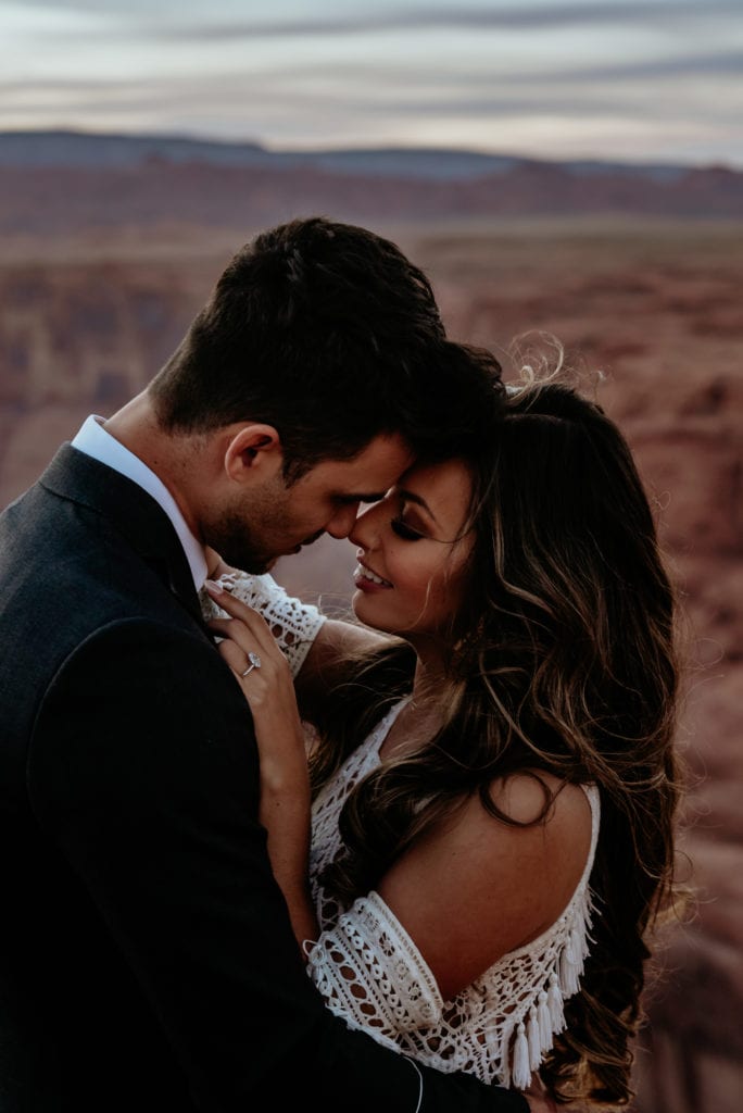 Bride and groom nuzzle during their Horseshoe Bend elopement