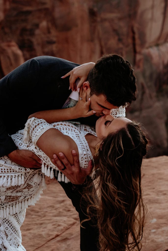 Groom dips his bride during Horseshoe Bend elopement