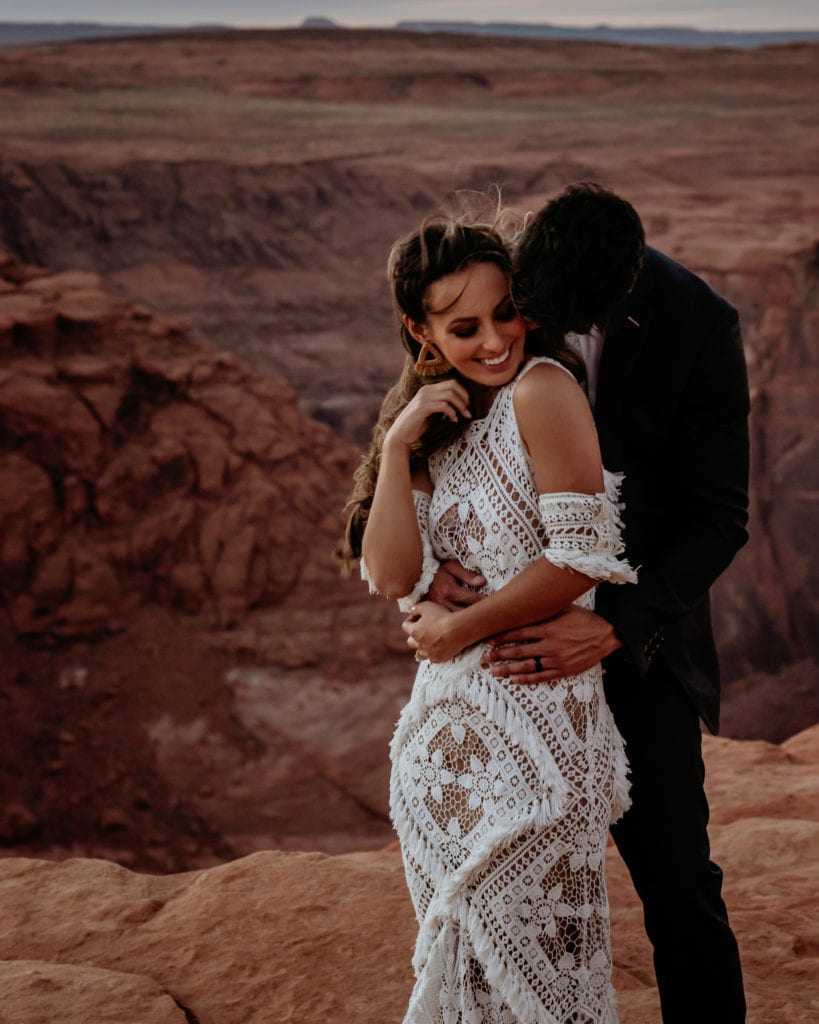 Couple smiles during their boho Page, Arizona elopement