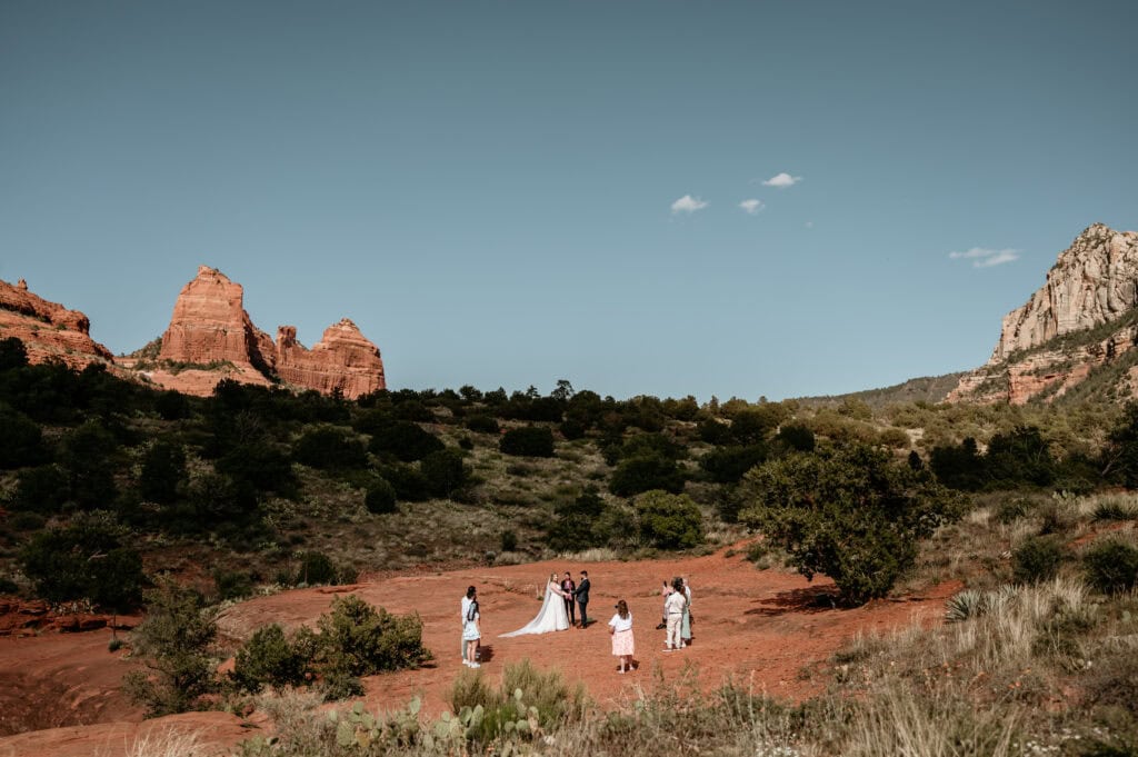 elopement couple surrounded by their family and friends during their wedding ceremony