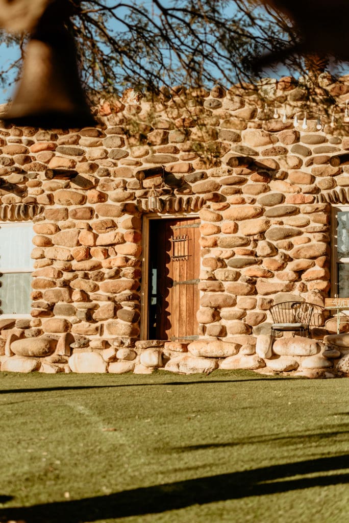 Southwest style door surrounded by river rock walls to the main house at Wranglers Roost in New River, Arizona