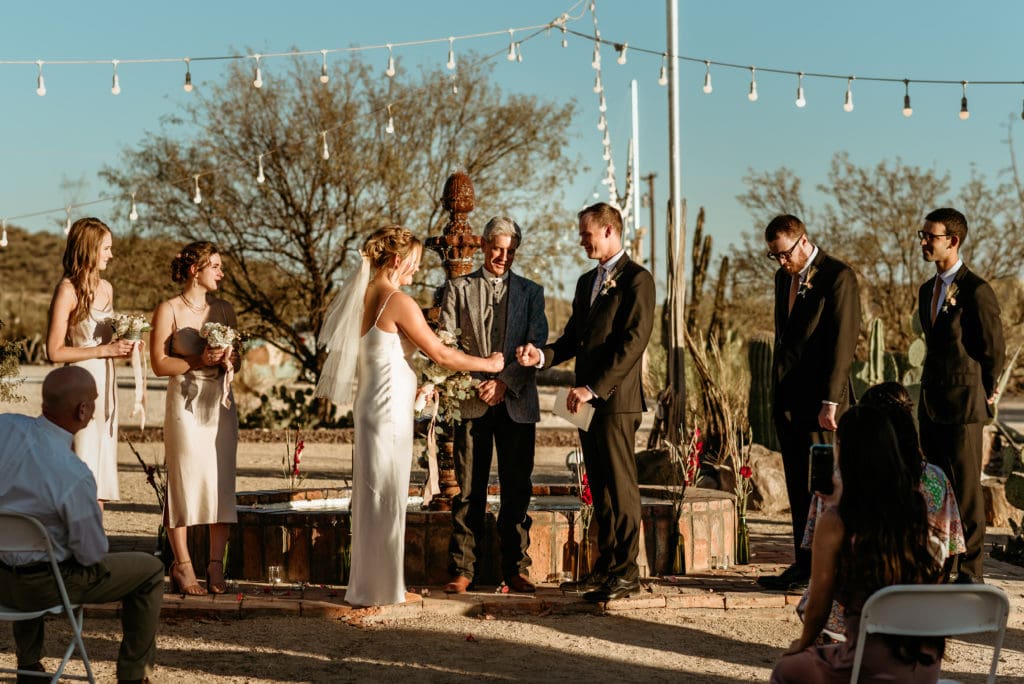 Bride and groom fist bump as part of their imitate Phoenix wedding ceremony