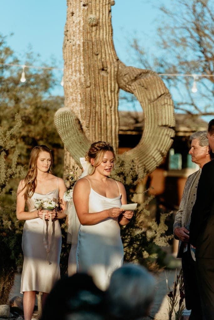 Bride reading her vows in front of a giant saguaro cactus at Wrangler Roost outside Phoenix, Arizona