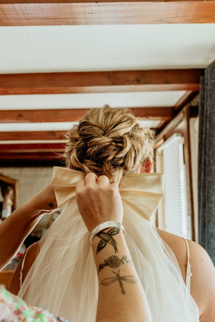 Mom pinning bride's late grandmother's veil