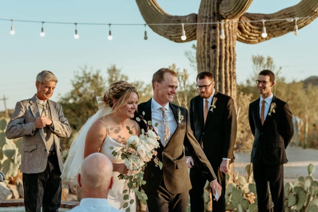 Couple smiling as they walk back up the isle during their Phoenix elopement