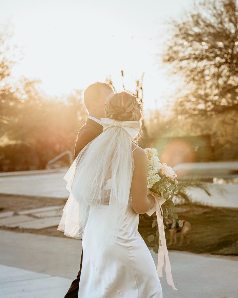 The first walk as husband and wife as the sun envelopes them after their Arizona desert ceremony