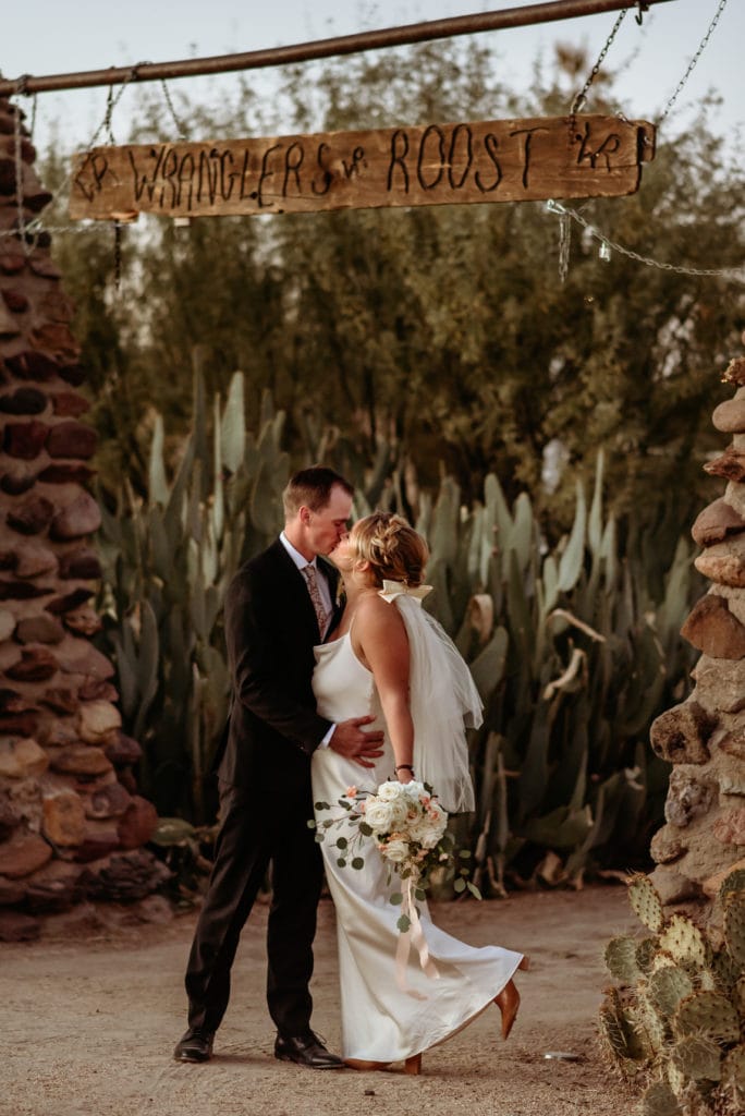 A stolen kiss under the rustic sign of Wranglers Roost