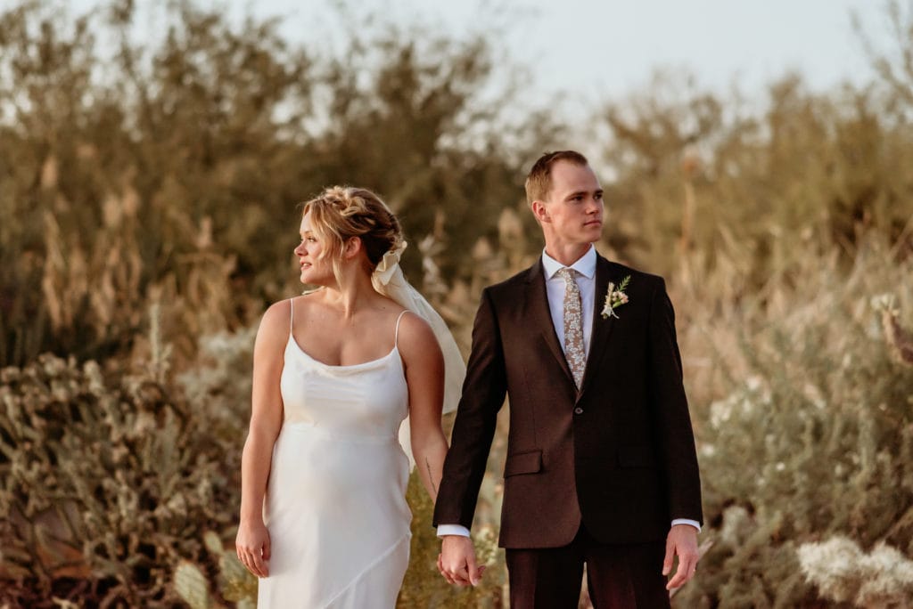 Couple holds hands as the sun sets on their Phoenix elopement
