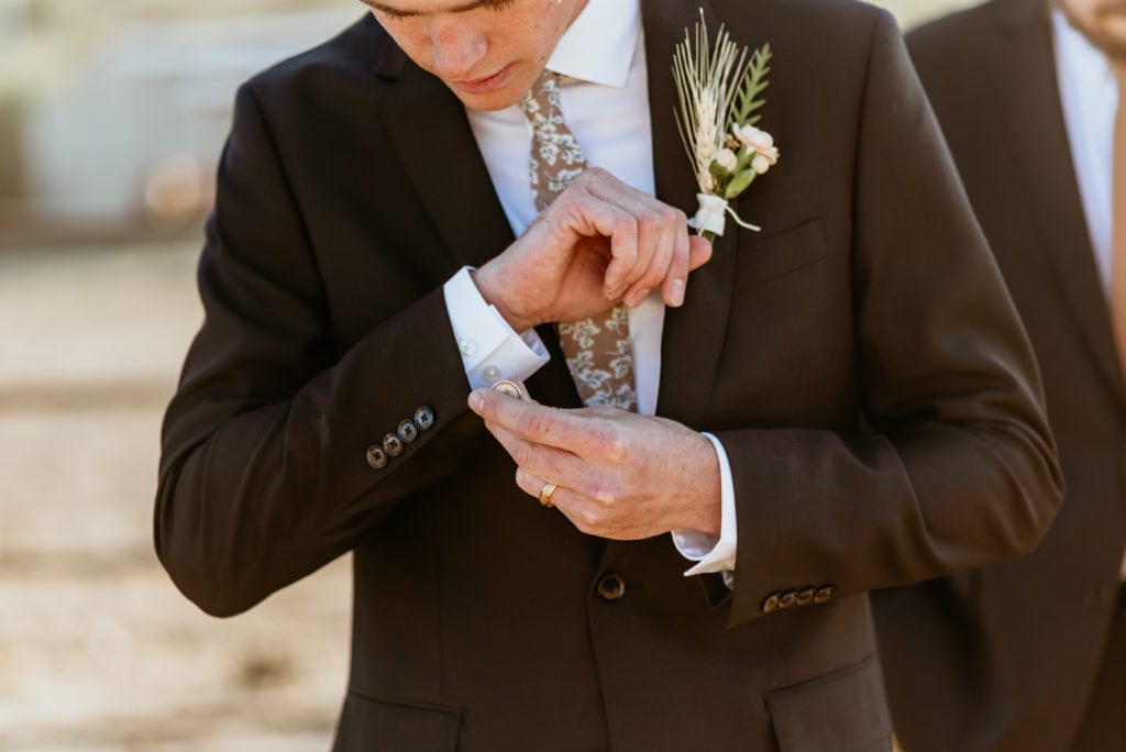 Groom adjusting his cufflinks