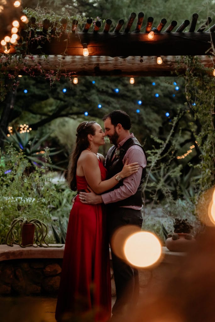 First dance in fire red wedding dress under the magical fairy lights at Tucson Botanical Gardens Wedding