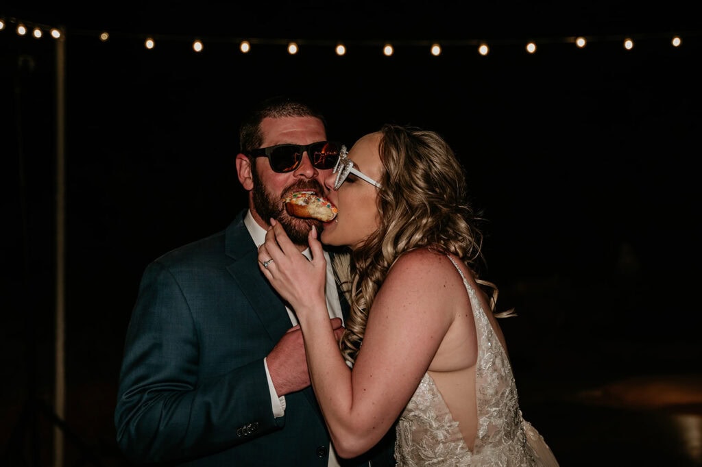 Bride and groom sharing a donut at their Red Agave Resort Wedding in Sedona, Arizona