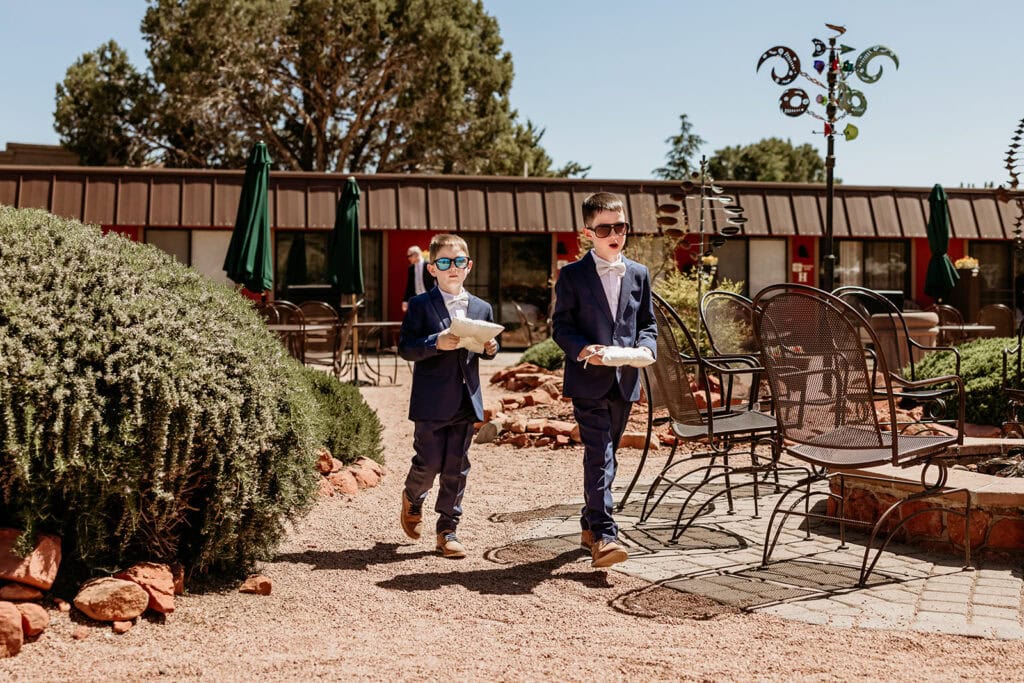 Ring bearers walking down the isle at the Red Agave Resort Wedding Venue in Sedona, Arizona