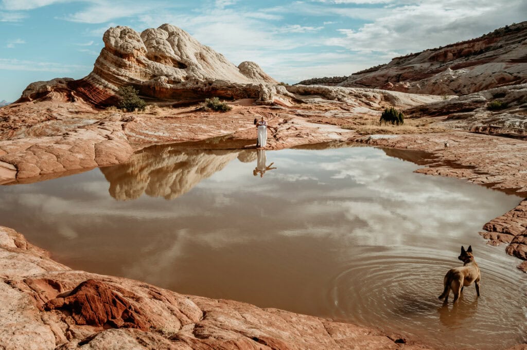 Groom holding bride with reflections during their remote offroad elopement in Arizona by elopement photographer Shannon Durazo
