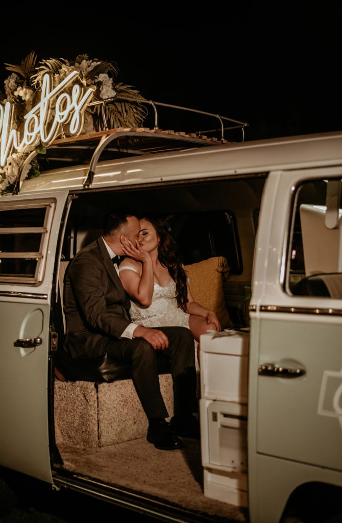 Couple enjoying their photobus at their Mariachi backyard wedding in Arizona