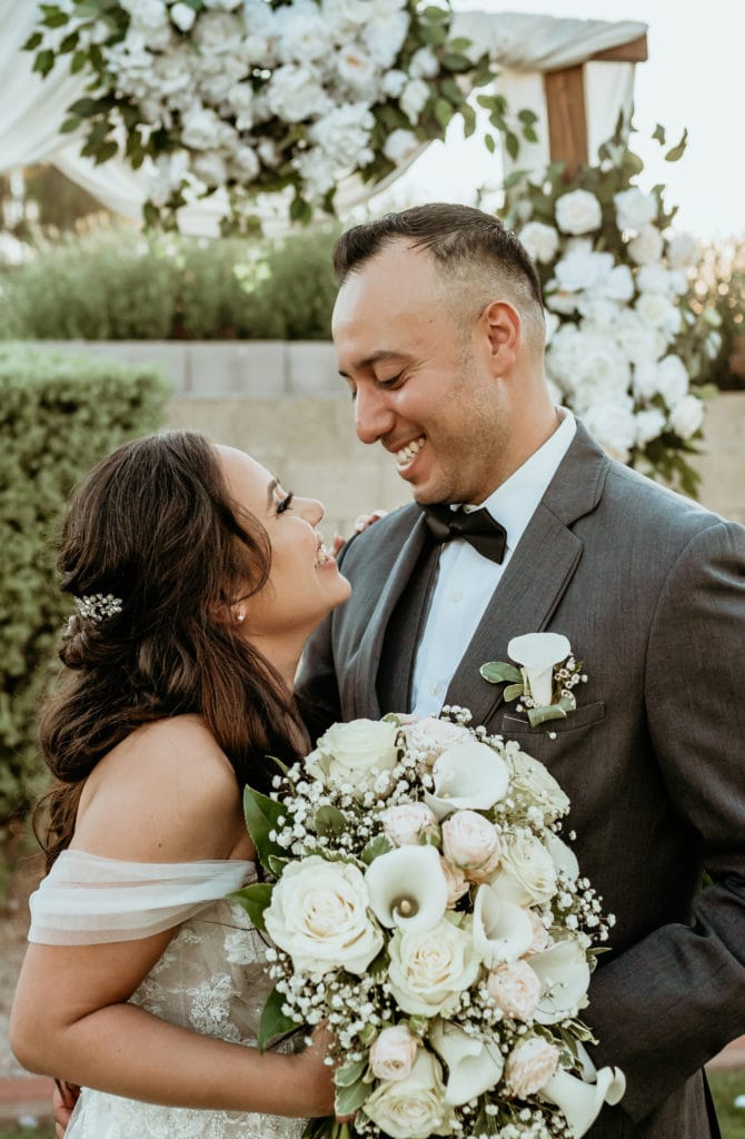 Bride and groom smiling at eachother