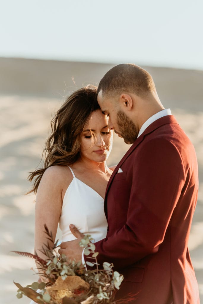 Intimate moments during a sand dune wedding