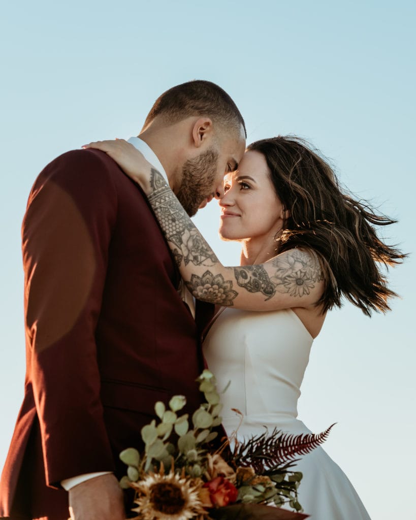 Bride and groom gazing into each others eyes, forehead to forehead, as they enjoy their first day as Mr. and Mrs.