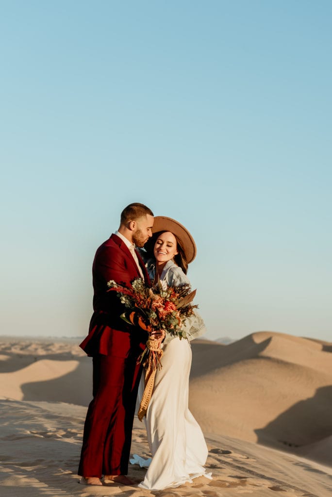 Boho wedding couple laughing during Glamis wedding sunset