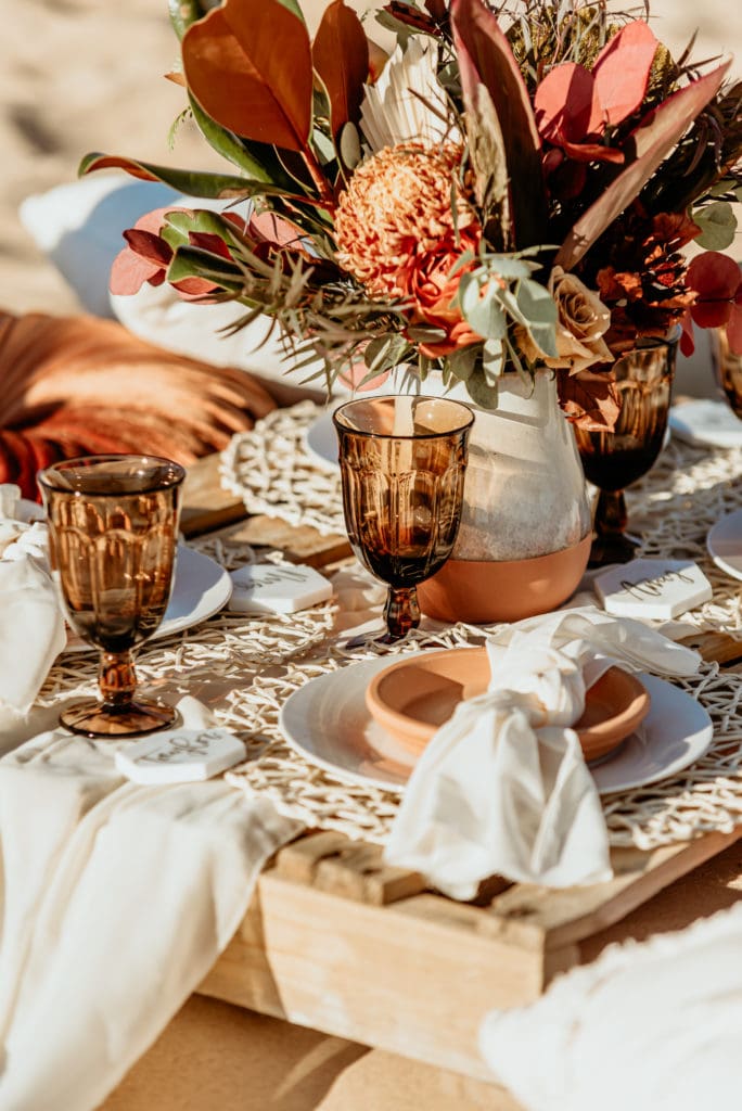 Earthy terracotta details in this boho chic picnic elopement setup