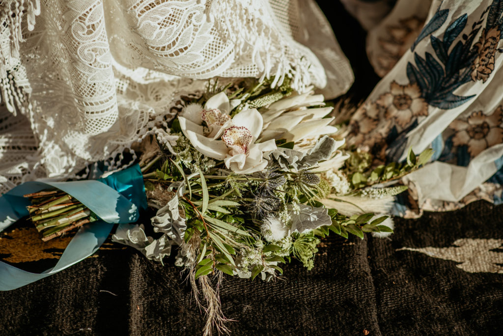Gorgeous white and blue bouquet with orchids during Baby Bell elopement