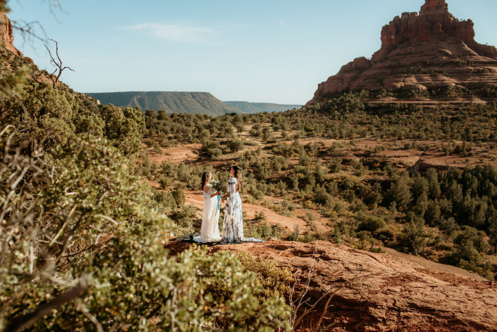 View of Bell rock as two brides say their elopement vows in Sedona, Arizona