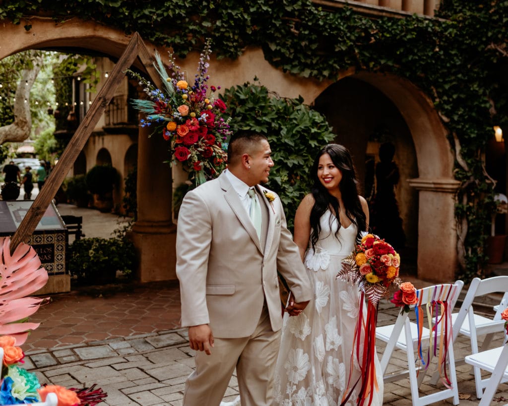 Bride and groom walking down the isle at Tlaquepaque