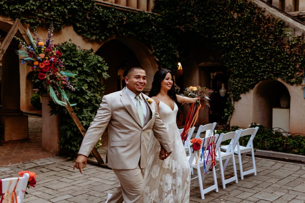 Couple celebrating as they walk up the isle