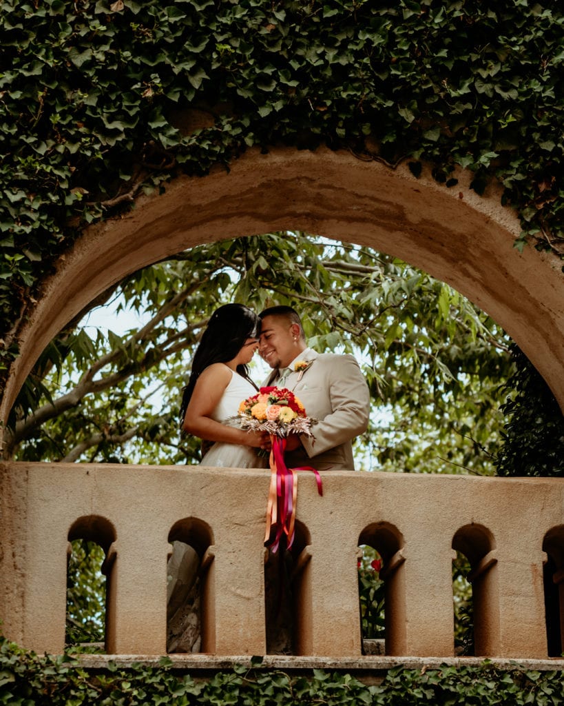 Bride and groom on ivy lined balcony at Tlaquepaque